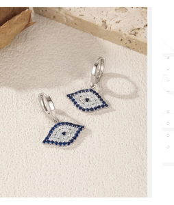 Detailed close-up of S925 sterling silver evil eye drop earrings with blue cubic zirconia