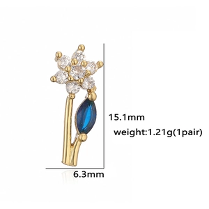 Detail view of gold flower earrings with white stones and blue leaf, size 15.1mm x 6.3mm
