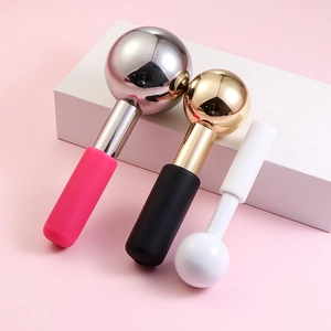 Three assorted stainless steel ice globe facial massagers on a sleek display stand