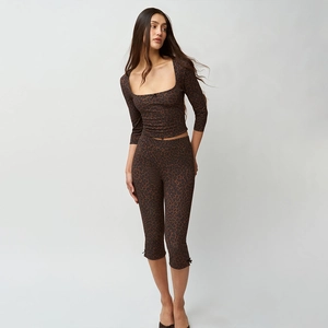 Detail shot of the sexy brown leopard print set featuring long sleeves and crop top