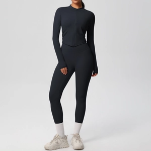 Détail d'un ensemble de sport noir avec haut zippé à manches longues et pantalon de yoga
