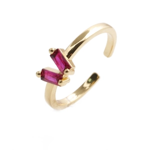 Detail of gold open ring featuring two rectangular rose pink zircon stones on white background