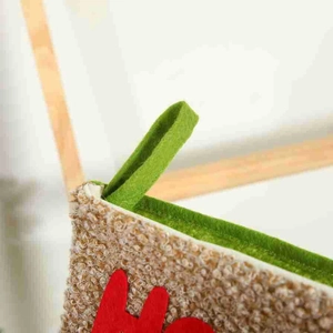 Christmas stocking in beige boucle fabric with green felt hook and red letter details
