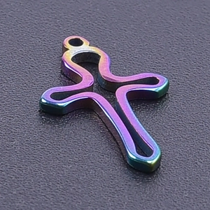 Macro shot of 304 stainless steel rainbow hollow cross pendant with metallic finish