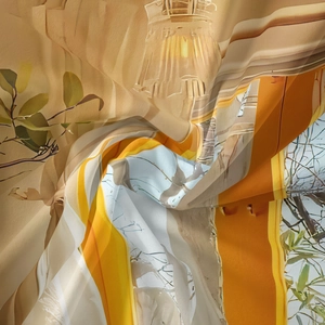 Close-up detail of Bohemian wall tapestry with artistic leaf patterns and warm colors
