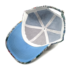 Detail of floral baseball cap interior showing blue brim and metal adjustable buckle