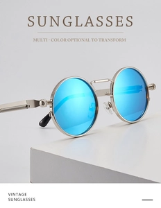 Detail of round steampunk sunglasses with silver metal frame and blue mirrored lenses
