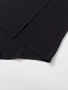 Detail of the high-quality stitching and hemline on a black crepe casual maxi dress