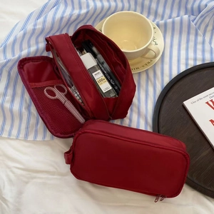 Detail view of double-layer nylon pencil case showing mesh compartments and stationery slots