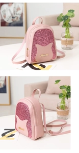 Detail of a pink sequin mini backpack with metallic logo plate and stylish PU leather accents