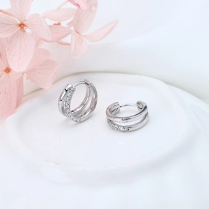 S925 sterling silver double hoop earrings with white zircon on a white plate