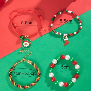 Detail view of festive Christmas charm bracelets with red rope and Santa pendants