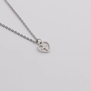 Silver stainless steel heart necklace with hollow cross pendant on a white background
