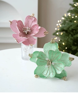 Detail of pink and green artificial Christmas flowers with glitter edges and bead centers