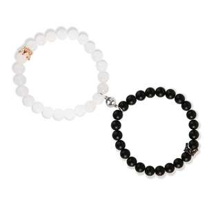 Detail of magnetic connection between black and white natural stone crown bracelets