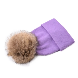 Detail of purple ribbed knit beanie with a fluffy brown faux fur pom pom for kids