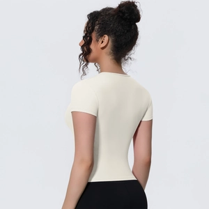 Detailed back view of a slim-fit, breathable yoga top featuring soft cream fabric and seams