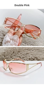 Detail of Y2K futuristic sunglasses with double pink lenses and gold hollow frame