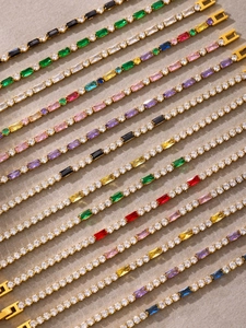 Detailed view of luxury gold-plated tennis bracelets with colorful baguette-cut zircons