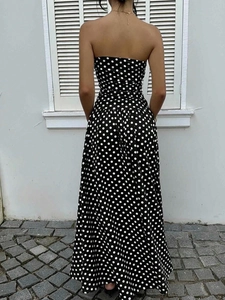 Detail of elegant black and white polka dot off-shoulder A-line maxi dress from the back