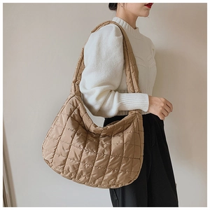 Detail of khaki quilted puffer shoulder bag with large capacity and diamond stitching