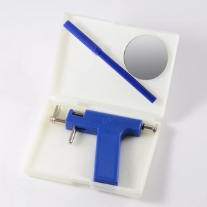Blue manual ear piercing gun kit with marker and mirror in a white storage case