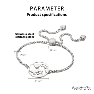 Macro detail of adjustable stainless steel bracelet featuring a world map charm and heart drops