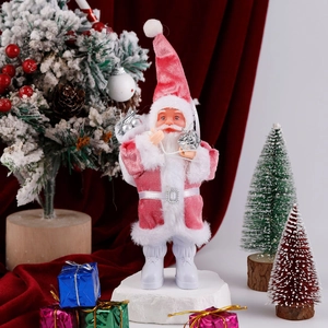 Detailed view of plush pink and white Santa figurine on a snowy festive scene setup