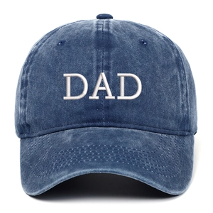 Close-up of DAD embroidery on dark blue washed cotton baseball cap with curved brim