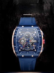 Detail of blue quartz watch with silicone strap, rose gold casing and date display