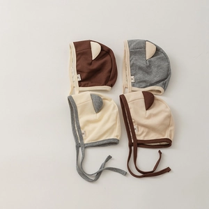 Detailed set of four newborn hats with cute bear ears and straps in various colors