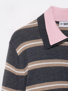 Close-up of the contrast pink collar and striped knit fabric on a stylish POLO shirt