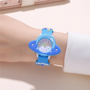 Macro shot of light blue UFO shaped children's watch with rocket strap details