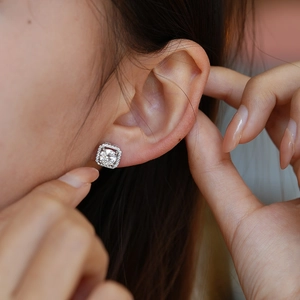 Elegant Cushion Halo Moissanite Stud Earrings in S925 Silver on a model ear