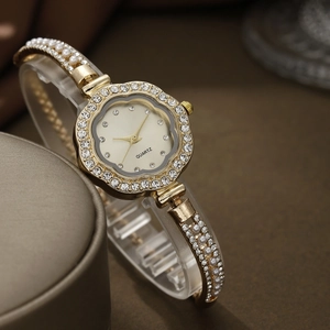 Detail of quartz watch featuring floral bezel with rhinestones and pearl accents