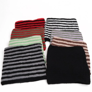Detail showing various striped knit cat ear beanies in vibrant color combinations
