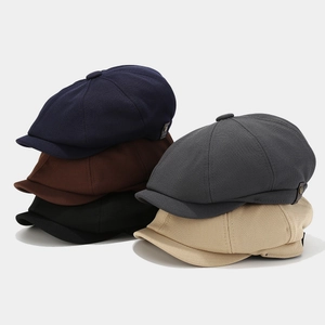 Classic newsboy caps collection in diverse colors with textured fabric and metal button details