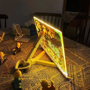 Illuminated acrylic LED message board with warm yellow glow and wooden desktop stand