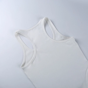Close-up of white ribbed knit fabric texture and neckline detail of the sports bodysuit