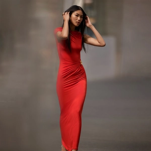 Detail view of red slim fit maxi dress featuring a golden decorative side waist buckle