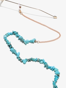 Detail of golden metal chain with blue turquoise stone beads and silicone eyeglass ends