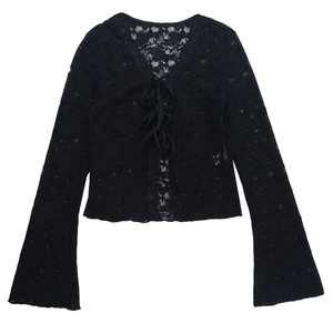 Close-up of black floral lace fabric with delicate tie-up front and bell sleeves