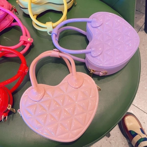 Close-up of heart-shaped PVC jelly bags with quilted patterns in various vibrant colors