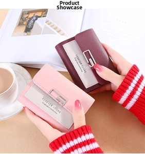 Pink and burgundy tri-fold wallets in synthetic leather with elegant metal buckle