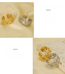 Detail of hollow floral pattern on adjustable stainless steel rings in gold and silver