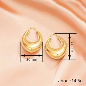 Minimalist thick teardrop gold earrings 30x39mm size guide on orange silk background