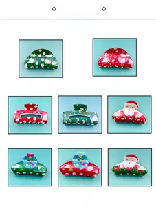 Detail view of 8 festive Christmas hair claw clips with Santa Claus and snowflake prints