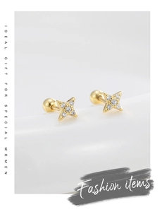 Detailed macro view of 14K gold star stud earrings with screw-back and clear zircon stones