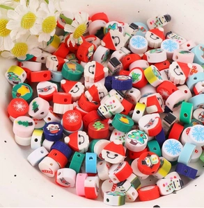 Close-up of festive polymer clay beads featuring Santa, snowman and Christmas tree designs