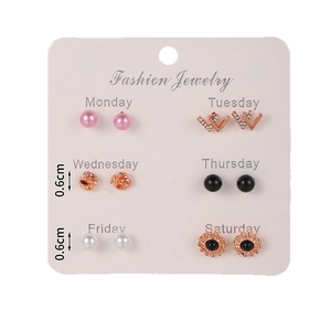 Set of 6 pairs heart and pearl stud earrings displayed on a white fashion jewelry card